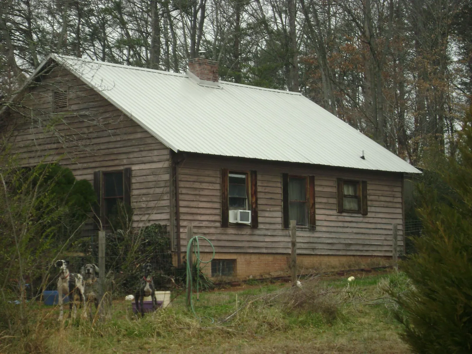 White metal roof on an old wood sided farmhouse, from a Metal Roof Installation job in Enola